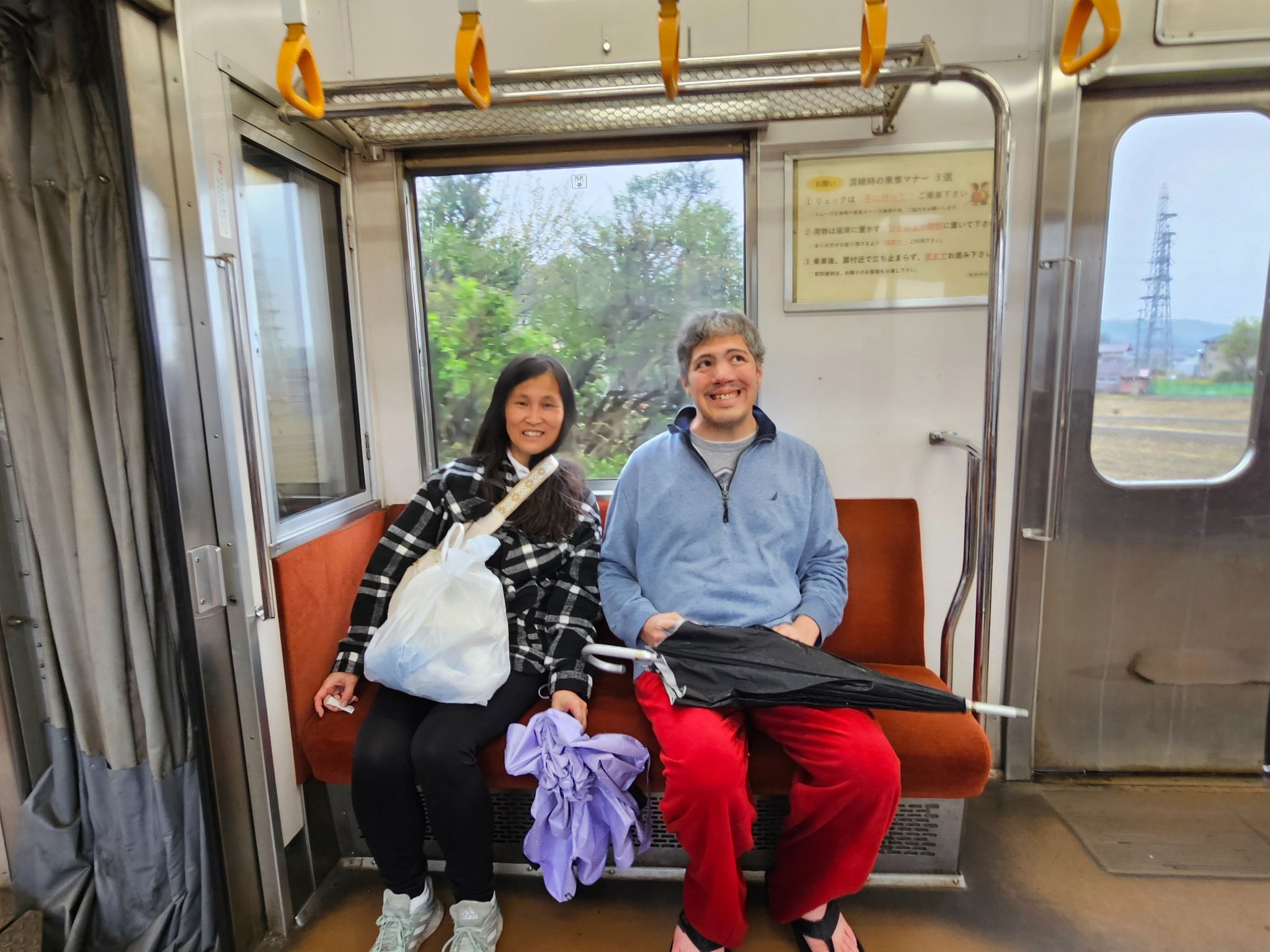 Tomoko and son on a rainy train ride.