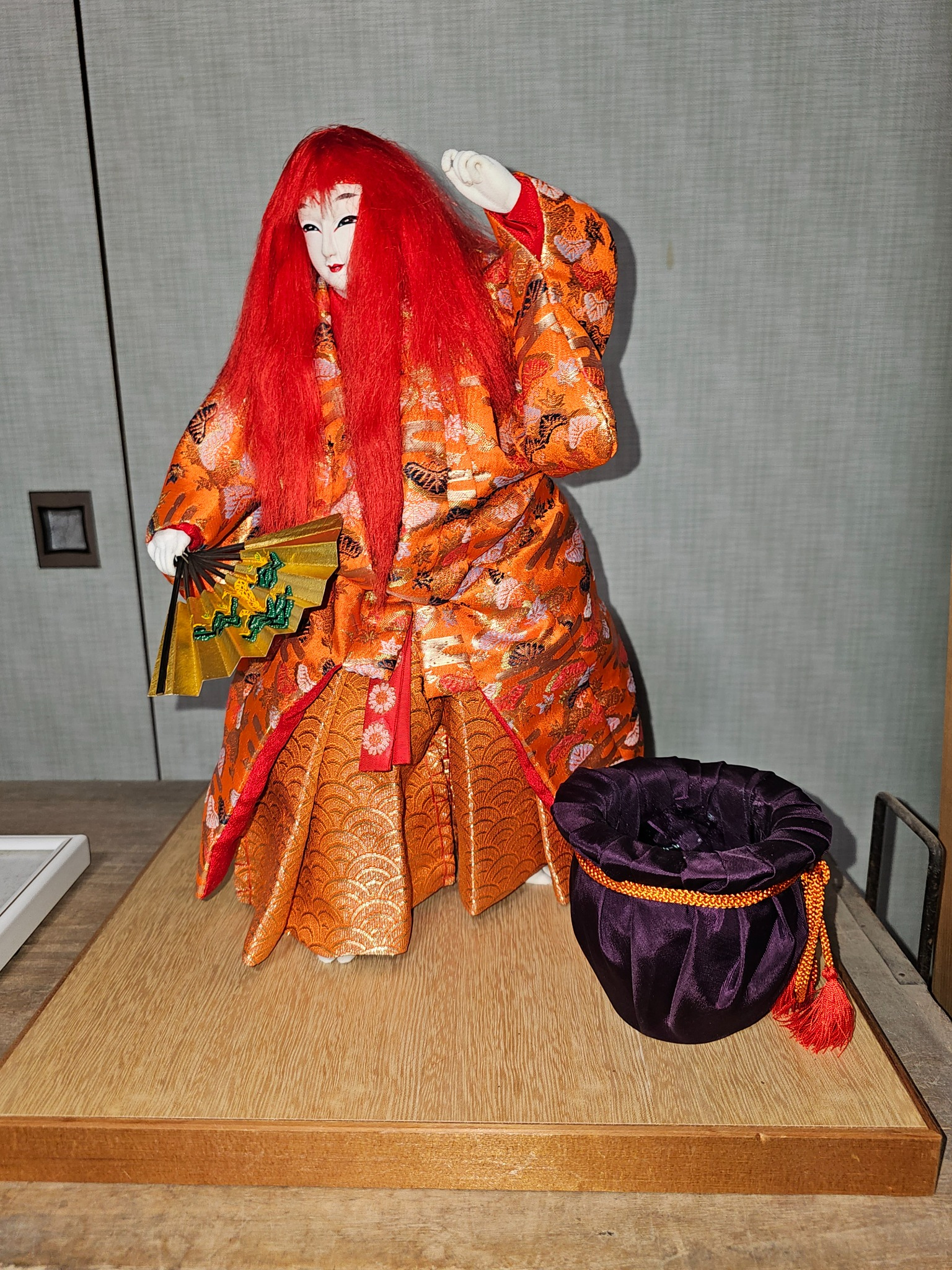 Red haired theatrical doll with fan.