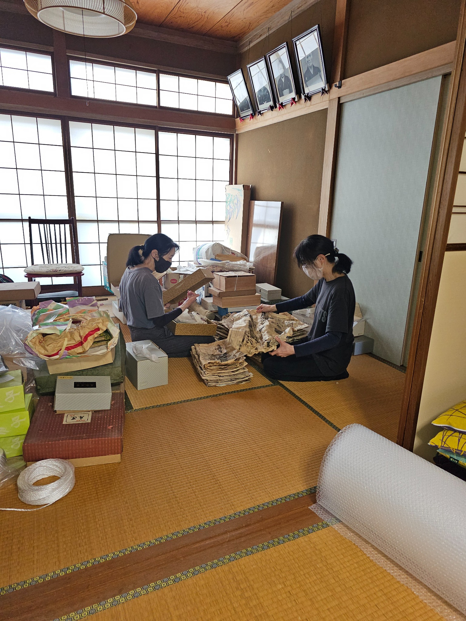 Twins and mother sorting a 1993 newspaper.