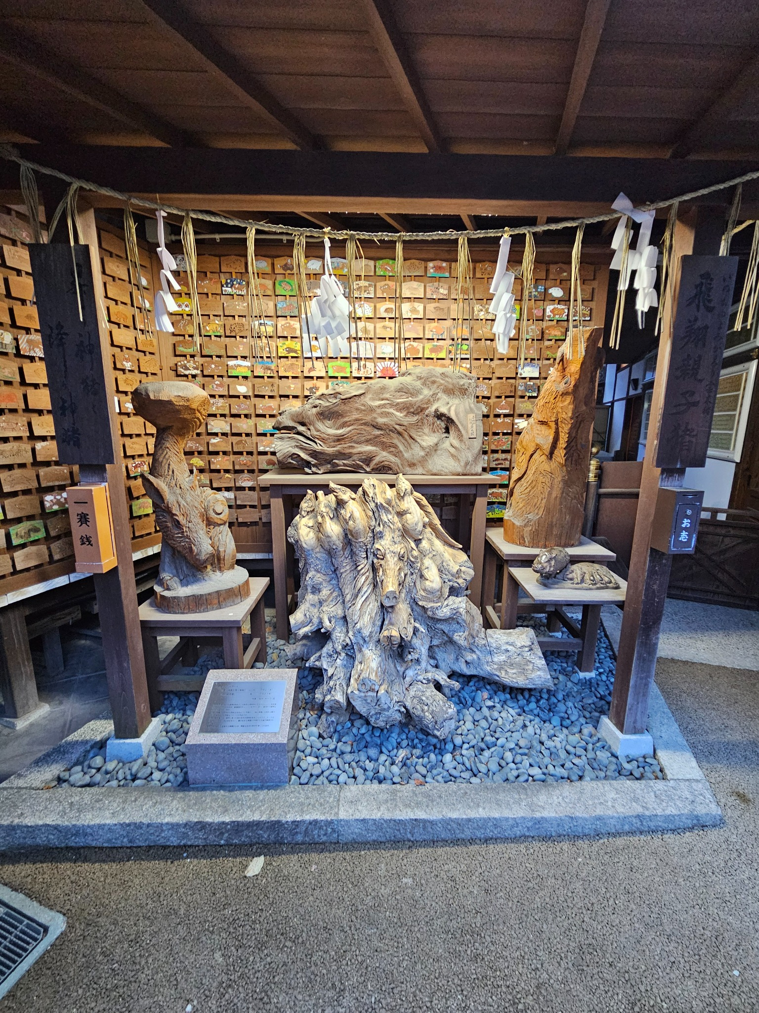 Root carved boars at Kyoto shrine.