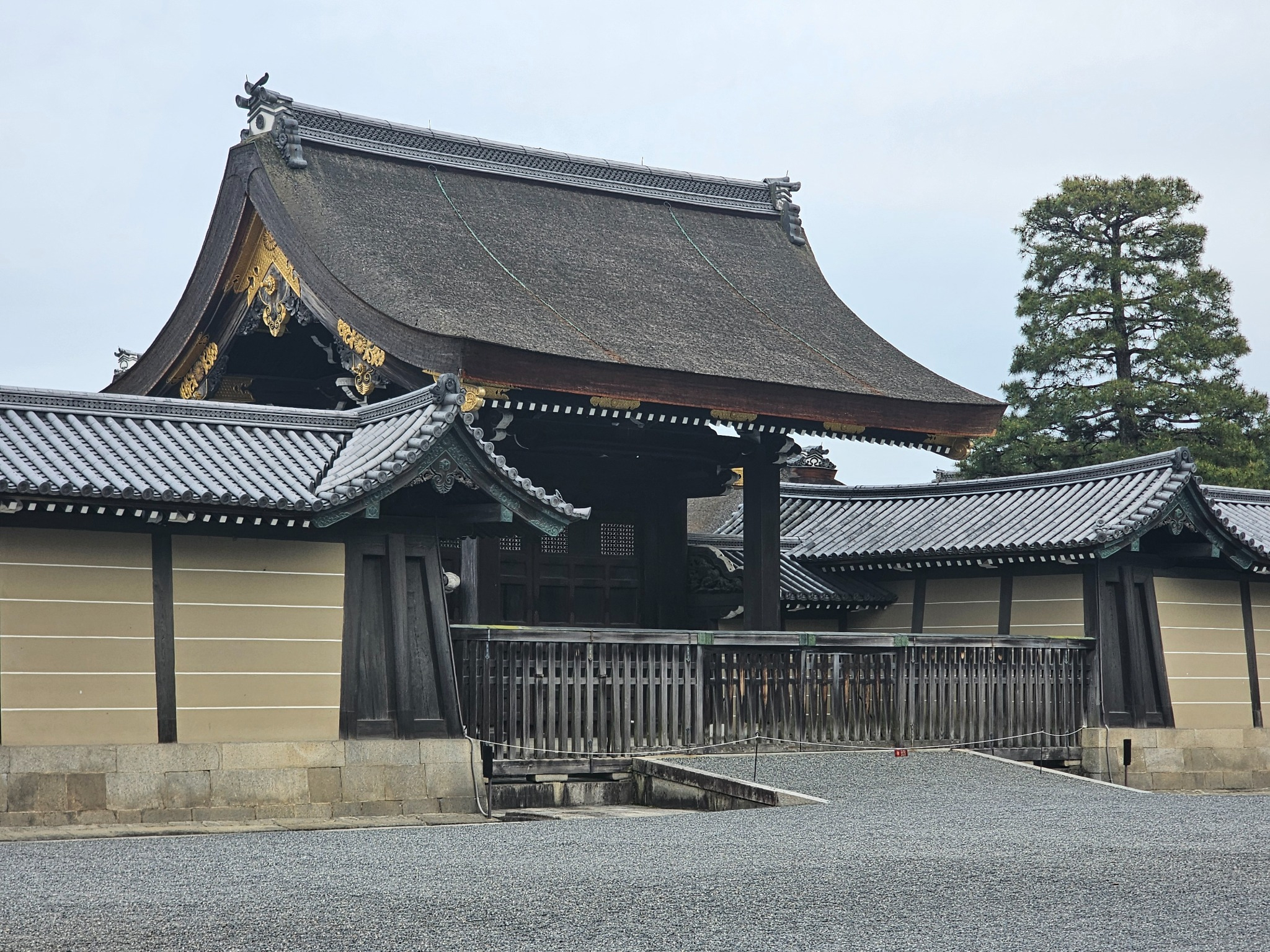 Large traditional gate with thatched roof in Kyoto.