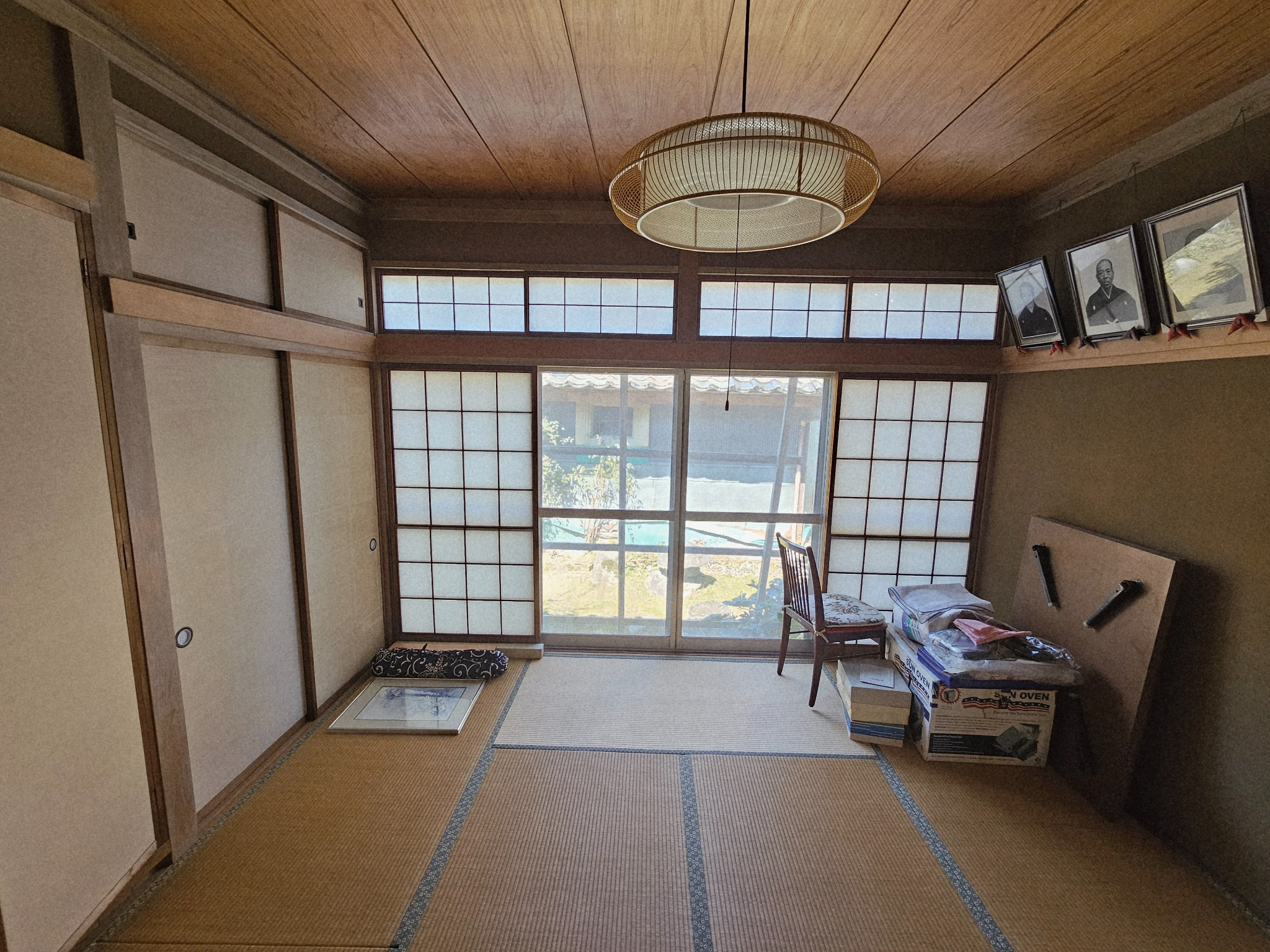An empty room in the Hanasaki house lit by window light.