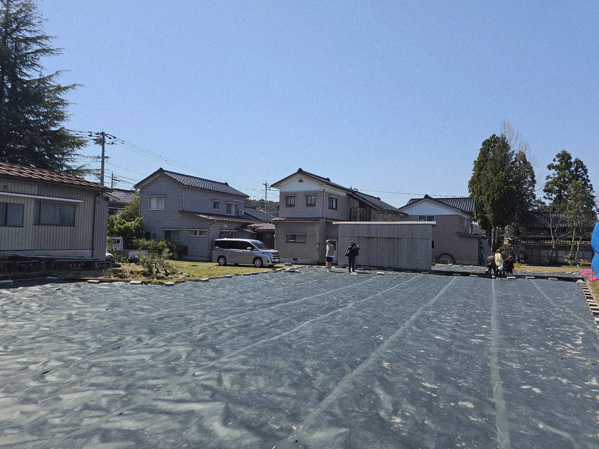 Cleared black ground and nearby buildings.