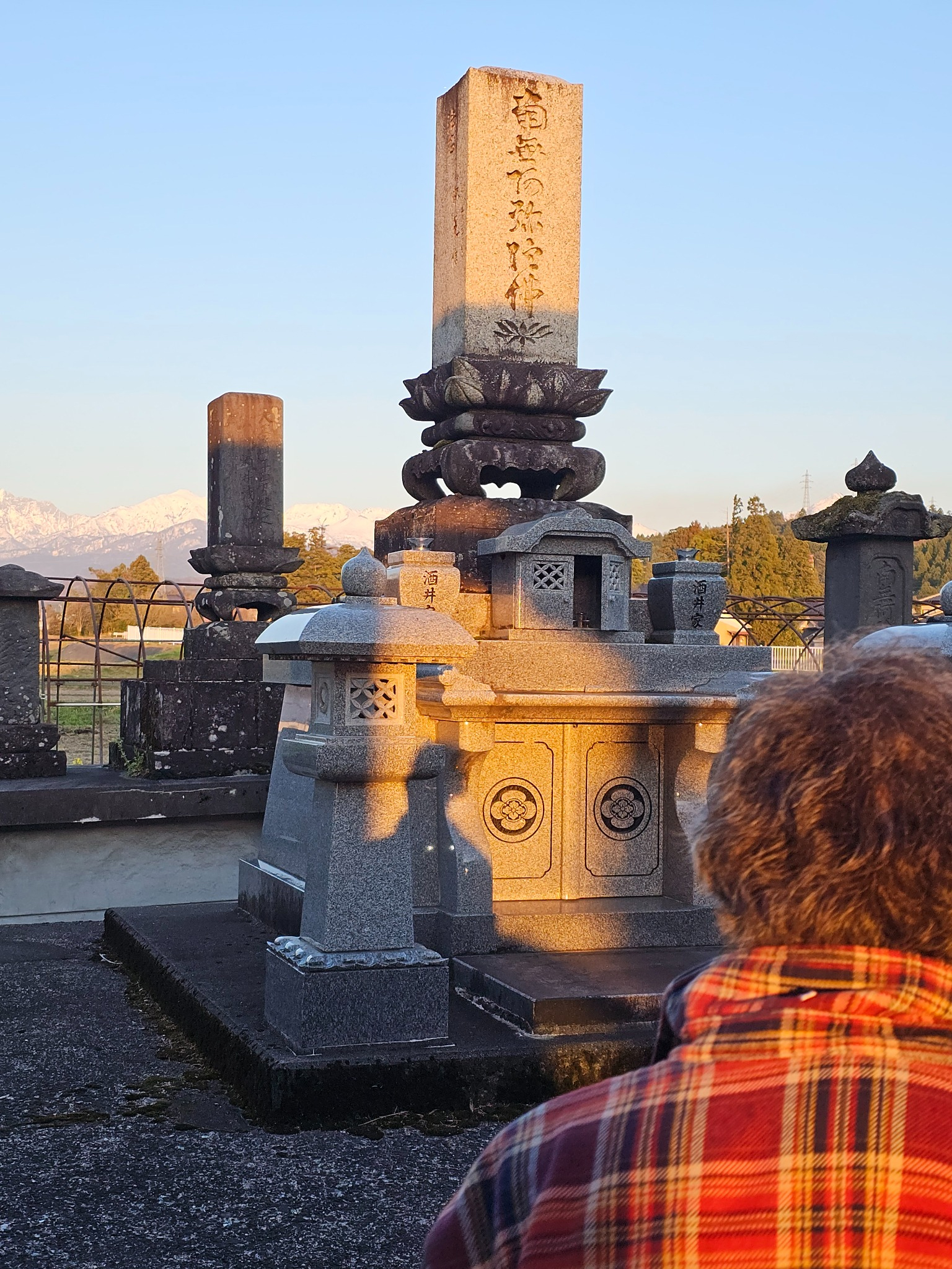 Sakai family grave with kura and family present.