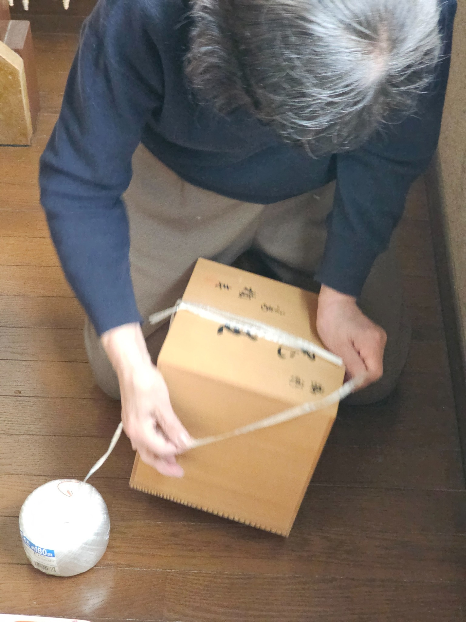 Box being tied for shipment.