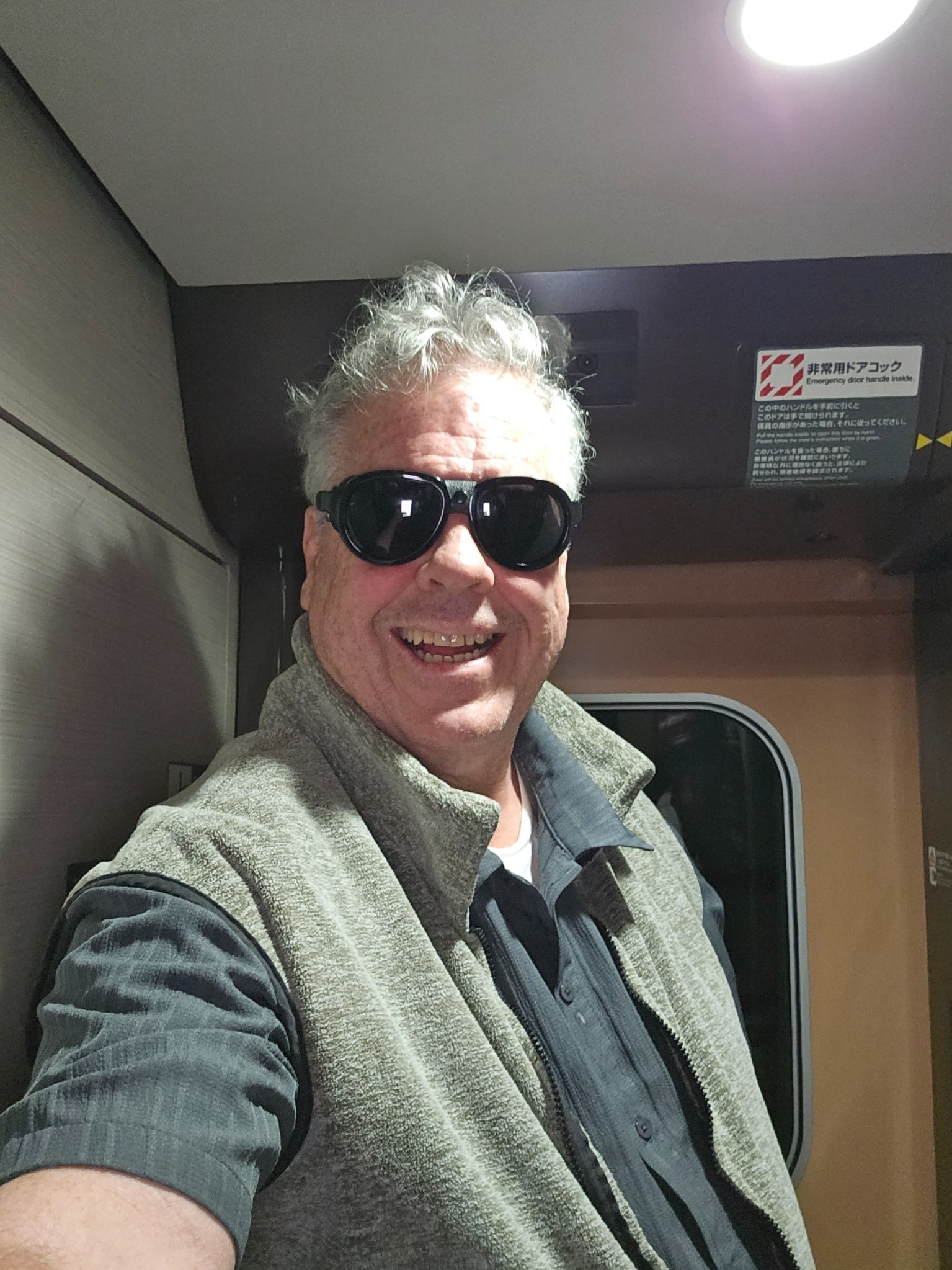 Brad in the Shinkansen wearing vest and goggles.