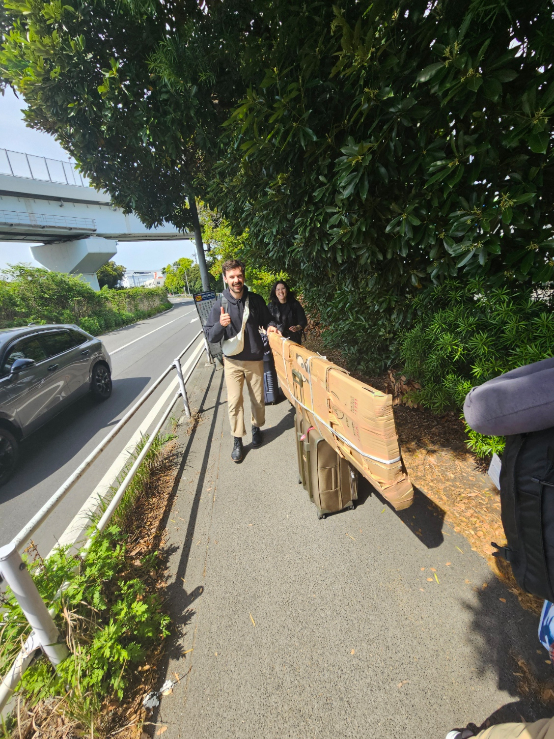 Friends helping with the long packed box.