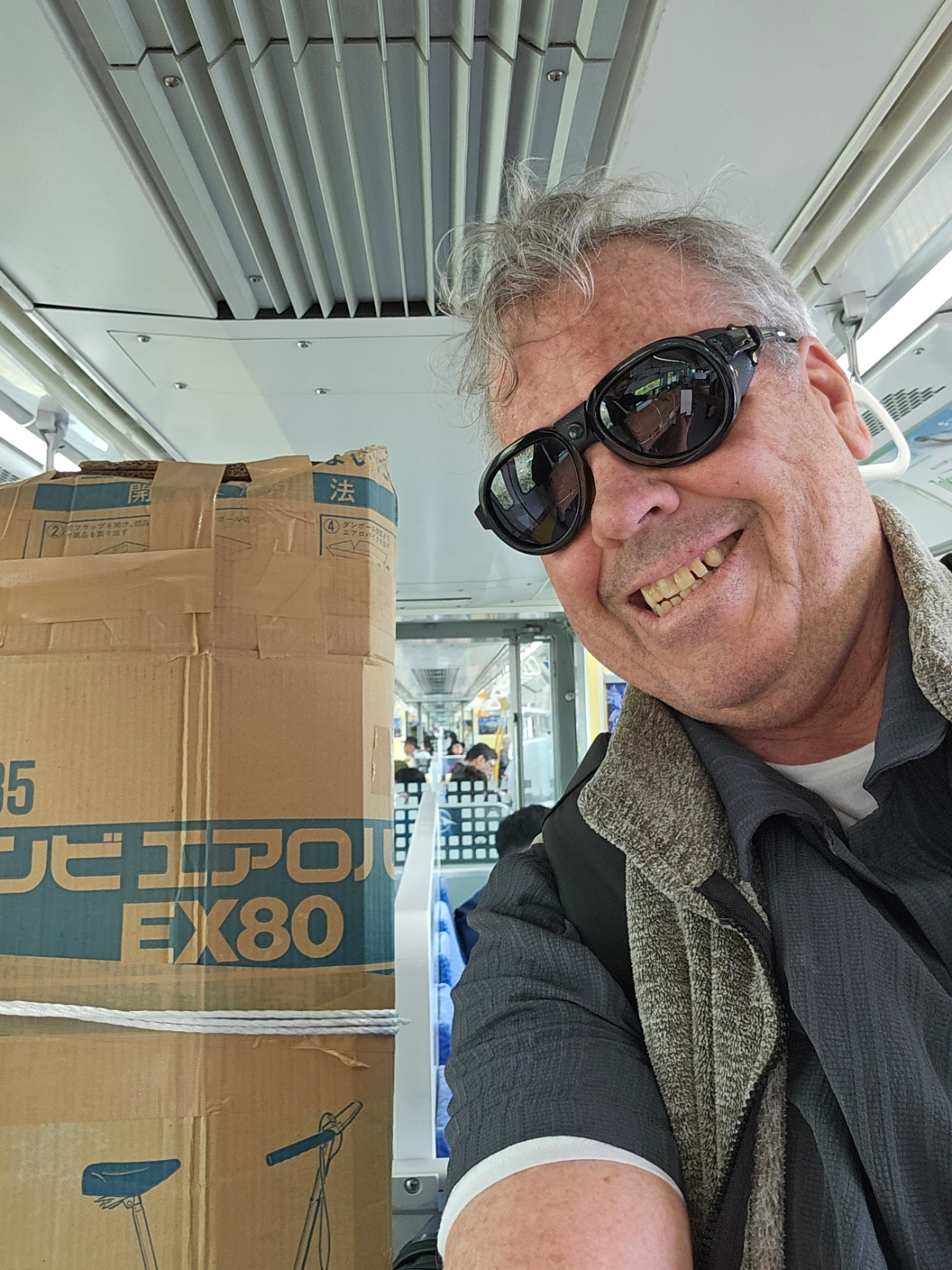 Brad selfie with the packed box on the monorail.