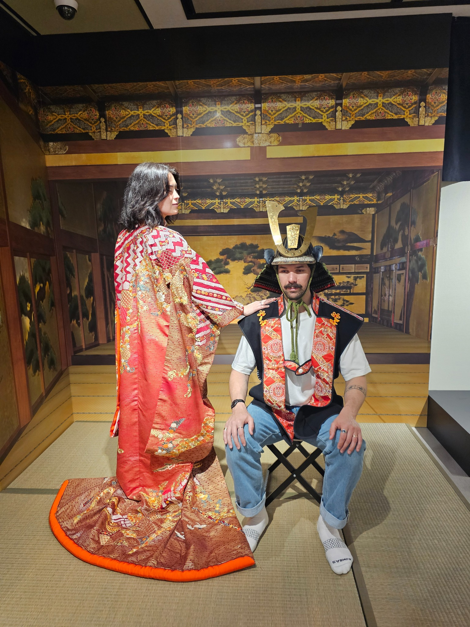 Couple in historical pose with red kimono.
