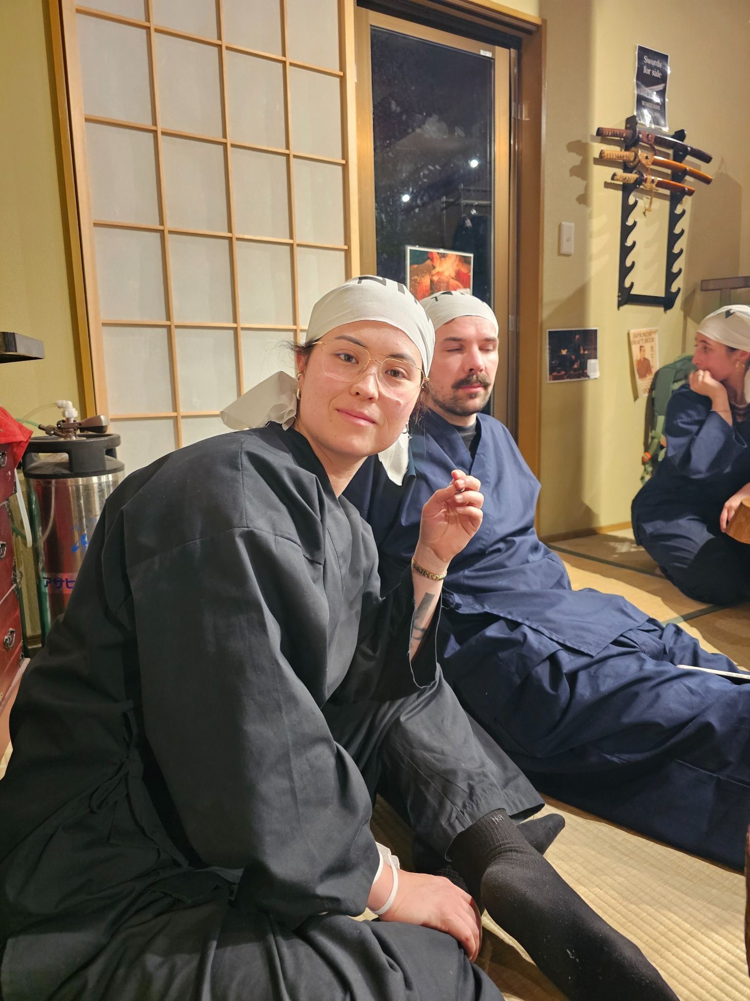 Two guests seated in workshop.